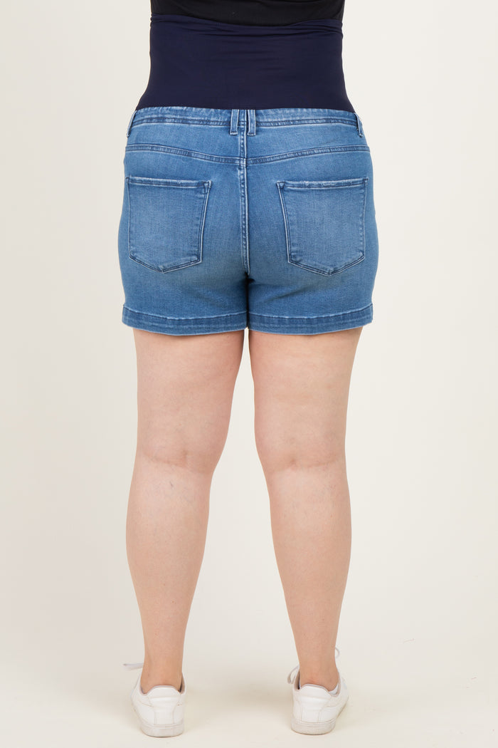 woman wearing a pair of blue maternity plus denim shorts, showing the back view with a supportive waistband