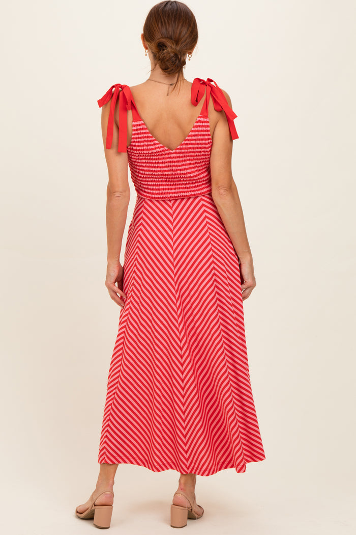 woman wearing a red and white striped maxi dress with smocked bodice and tie shoulder straps, shown from the back