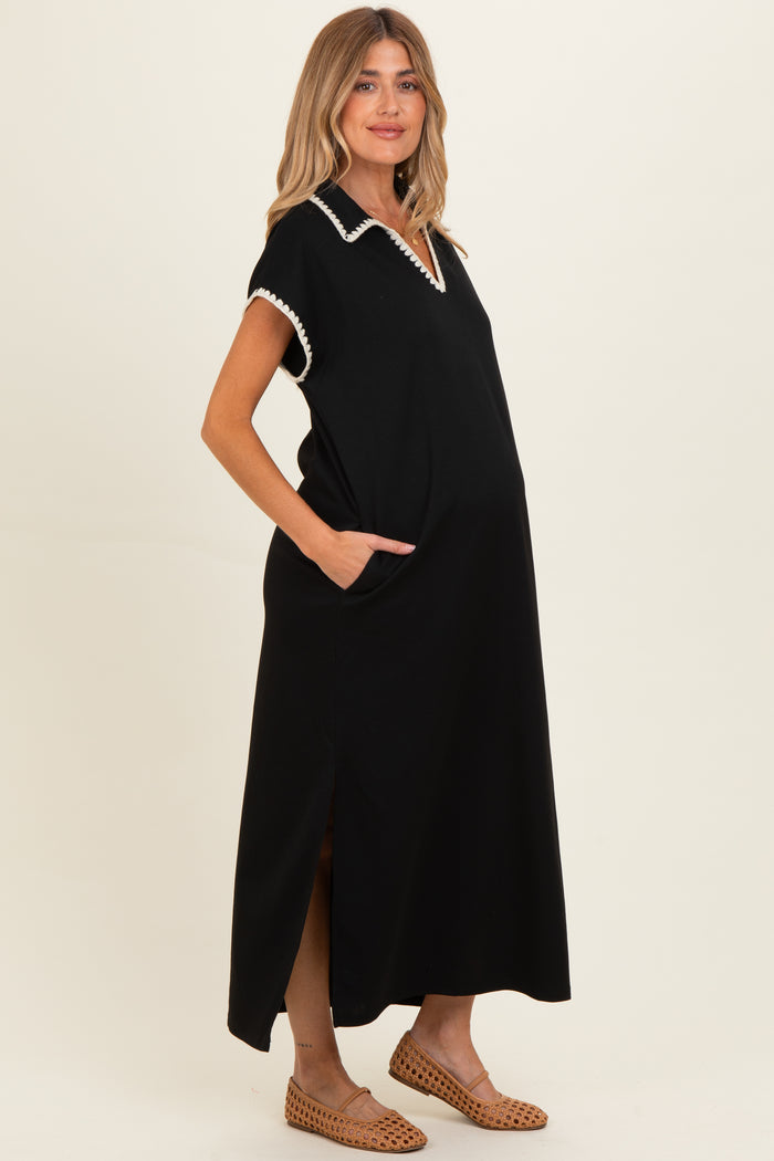 woman wearing a black maternity maxi dress with a collar and pockets, showing her baby bump