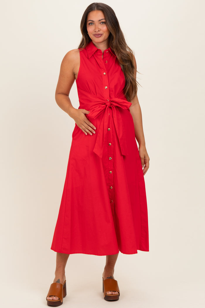woman wearing a red sleeveless maternity dress with a tied waist and button-down front