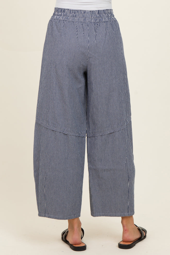 woman wearing navy blue striped wide-leg pants with an elastic waistband and a relaxed fit from the back