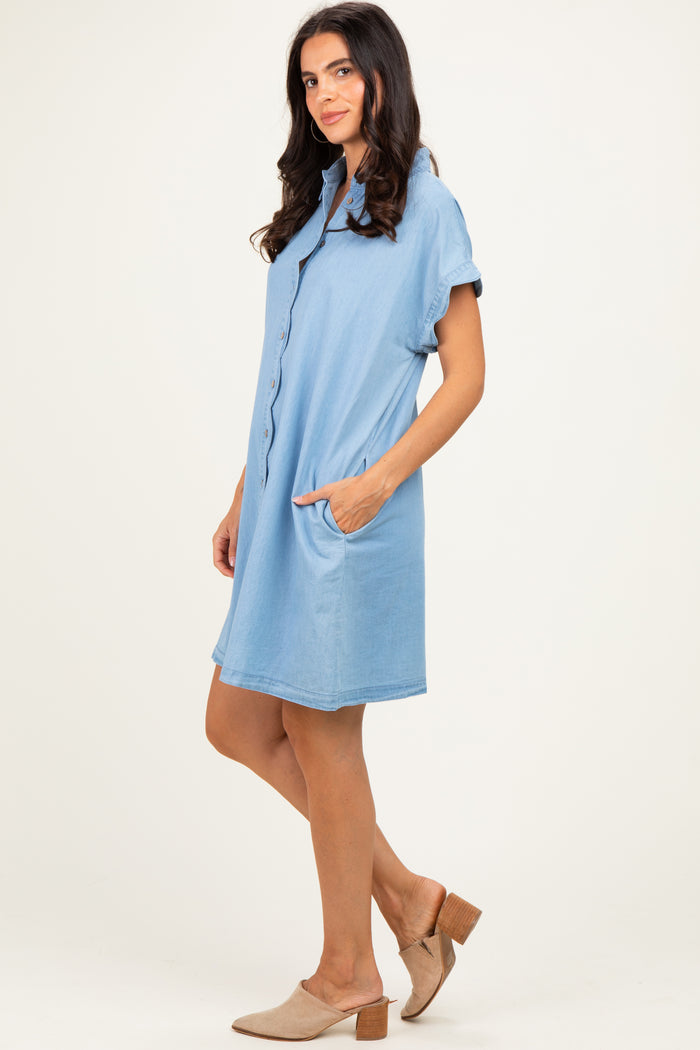 woman wearing a light blue button-up short sleeve dress with pockets and beige slide-on heels