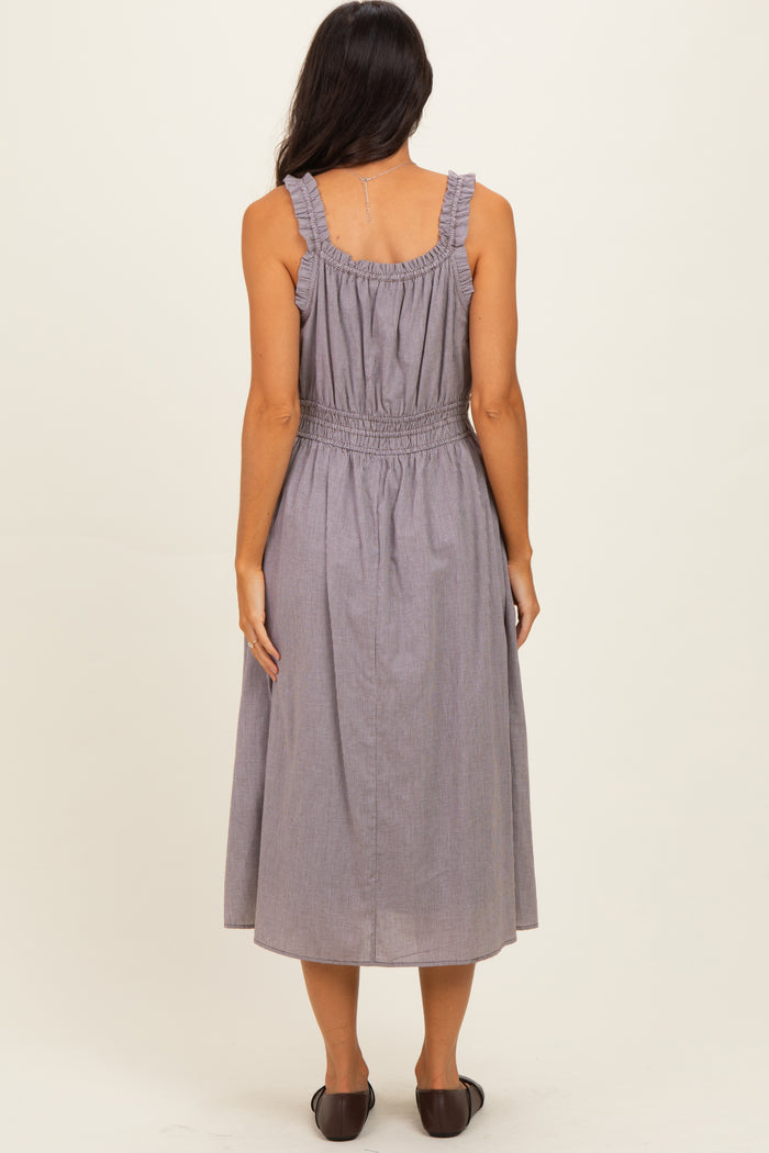 woman wearing a gray and white striped midi dress with ruffled straps and smocked waist, viewed from the back