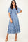 woman wearing a blue striped tiered midi dress with short sleeves and a smocked bodice, posing with one hand on her hip