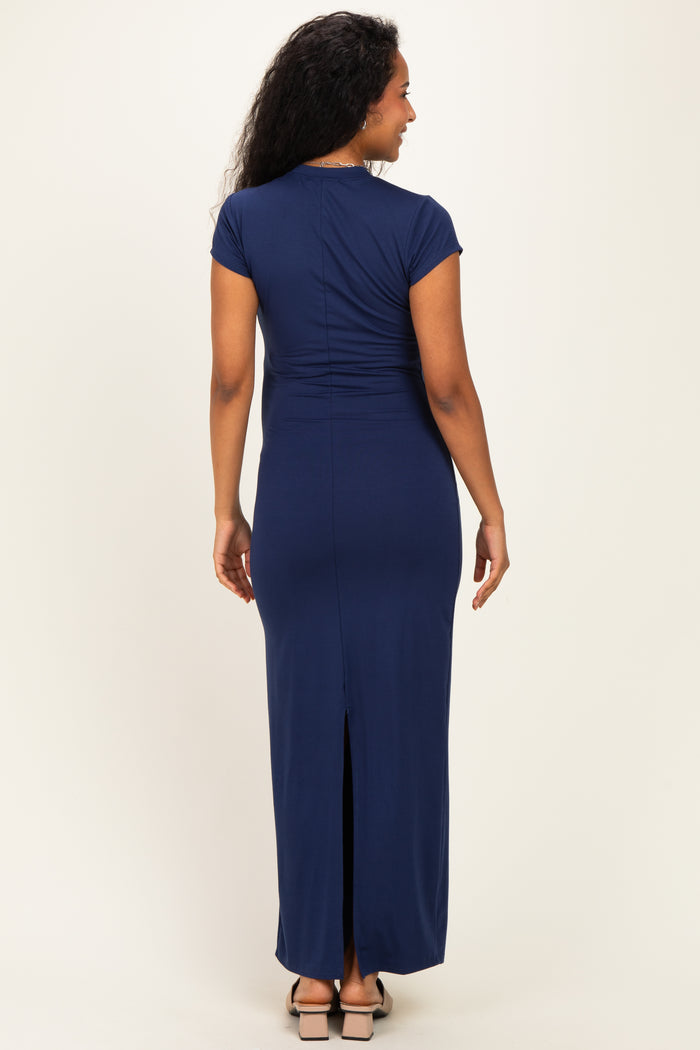 woman wearing a navy blue maternity maxi dress with short sleeves and a back slit