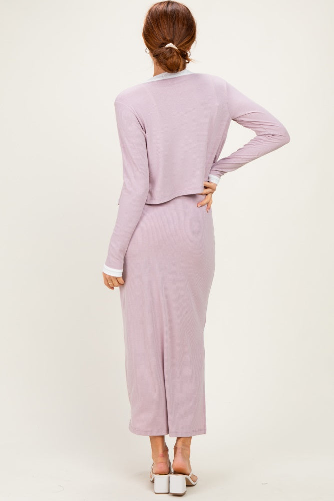 woman wearing a light lavender long sleeve maxi dress with a flowy back and a fitted silhouette