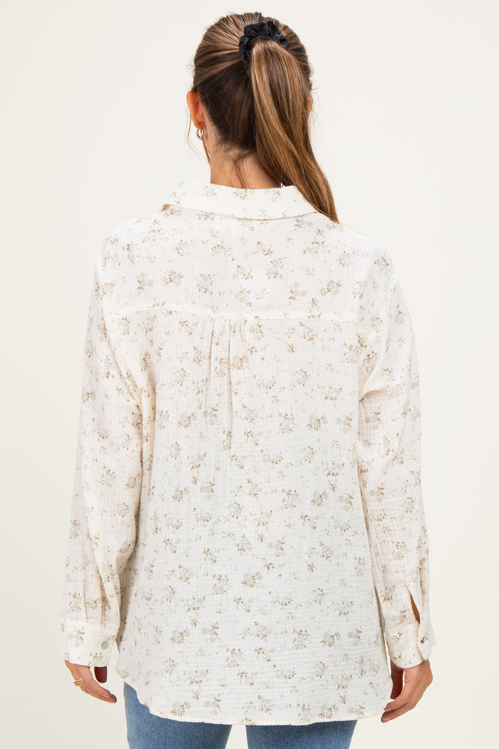 woman wearing a cream floral maternity top with a relaxed fit and long sleeves, seen from the back