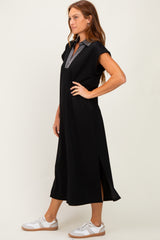 woman wearing a black sporty midi dress with a collared striped neckline and side slits, paired with white sneakers