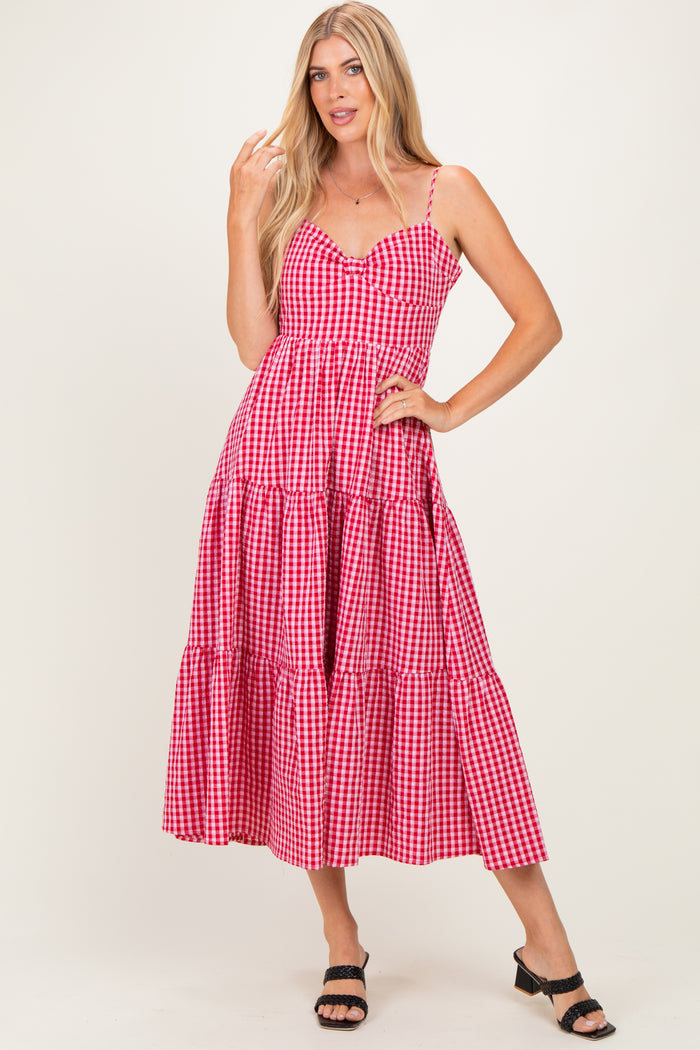 woman wearing a red and white gingham tiered maxi dress with thin straps and a v-neckline
