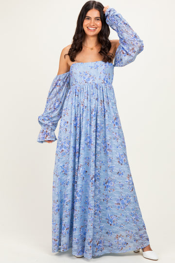 woman wearing a light blue off-shoulder maxi dress with floral print and long puff sleeves