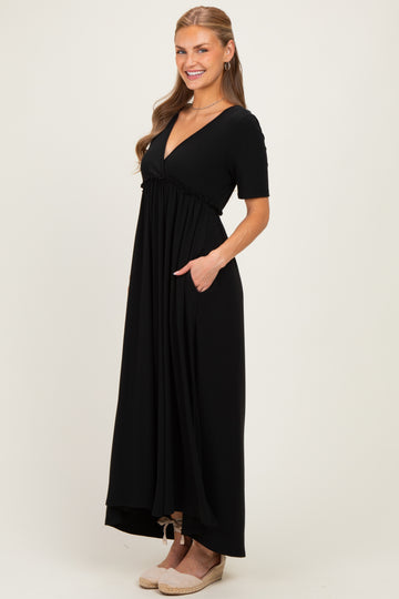 woman wearing a black short sleeve maxi dress with a deep v-neck and pockets, styled with wedge sandals