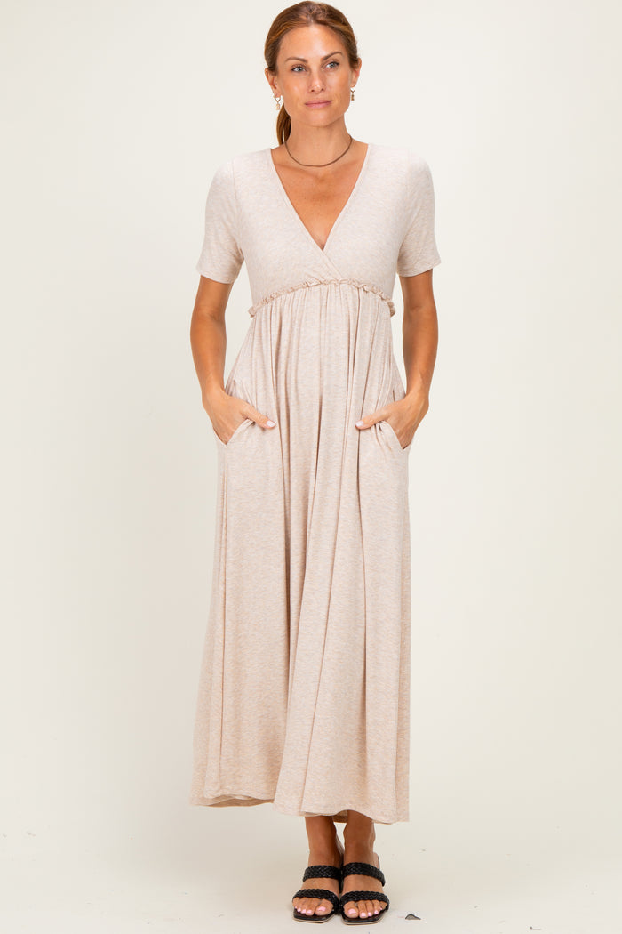 woman wearing a beige short sleeve maxi dress with a v-neck and pockets