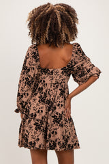 woman wearing a floral print maternity dress with puff sleeves and a square back design