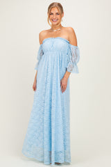 woman wearing a light blue off-the-shoulder lace maxi dress with bell sleeves and a fitted bodice