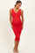 woman wearing a red ribbed maternity dress with a V-neckline and a fitted silhouette, showcasing her baby bump