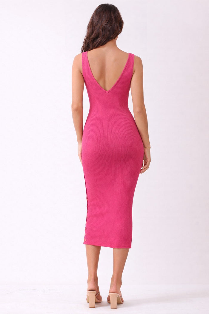 woman wearing a bright pink ribbed midi dress with a deep V-back and side buttons