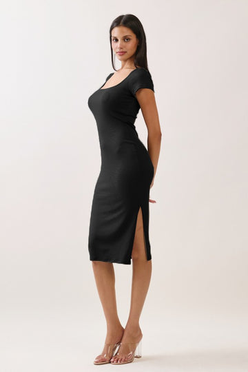 woman wearing a black bodycon dress with short sleeves and side slits