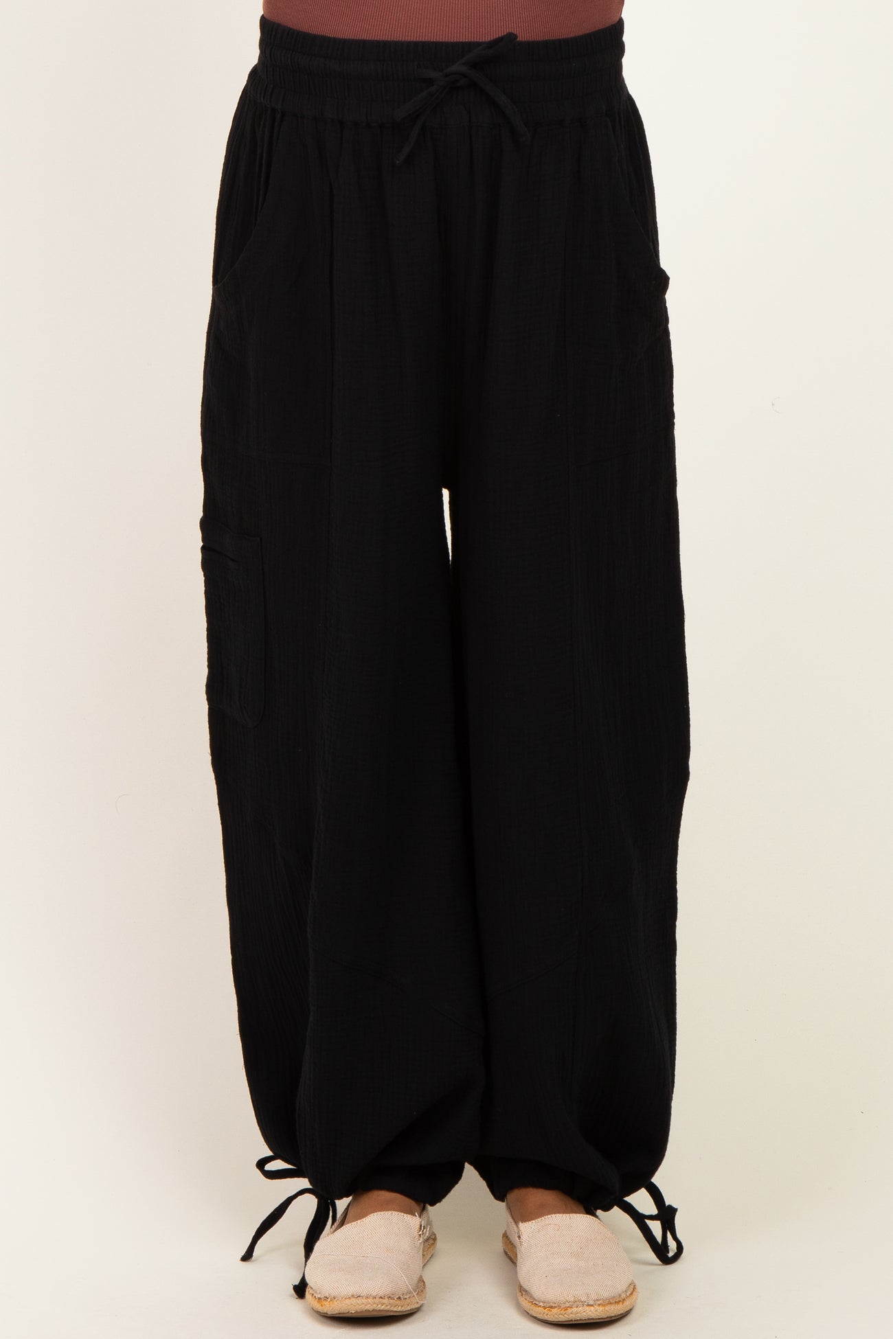 woman wearing black maternity wide-leg pants with drawstring waist and side pockets