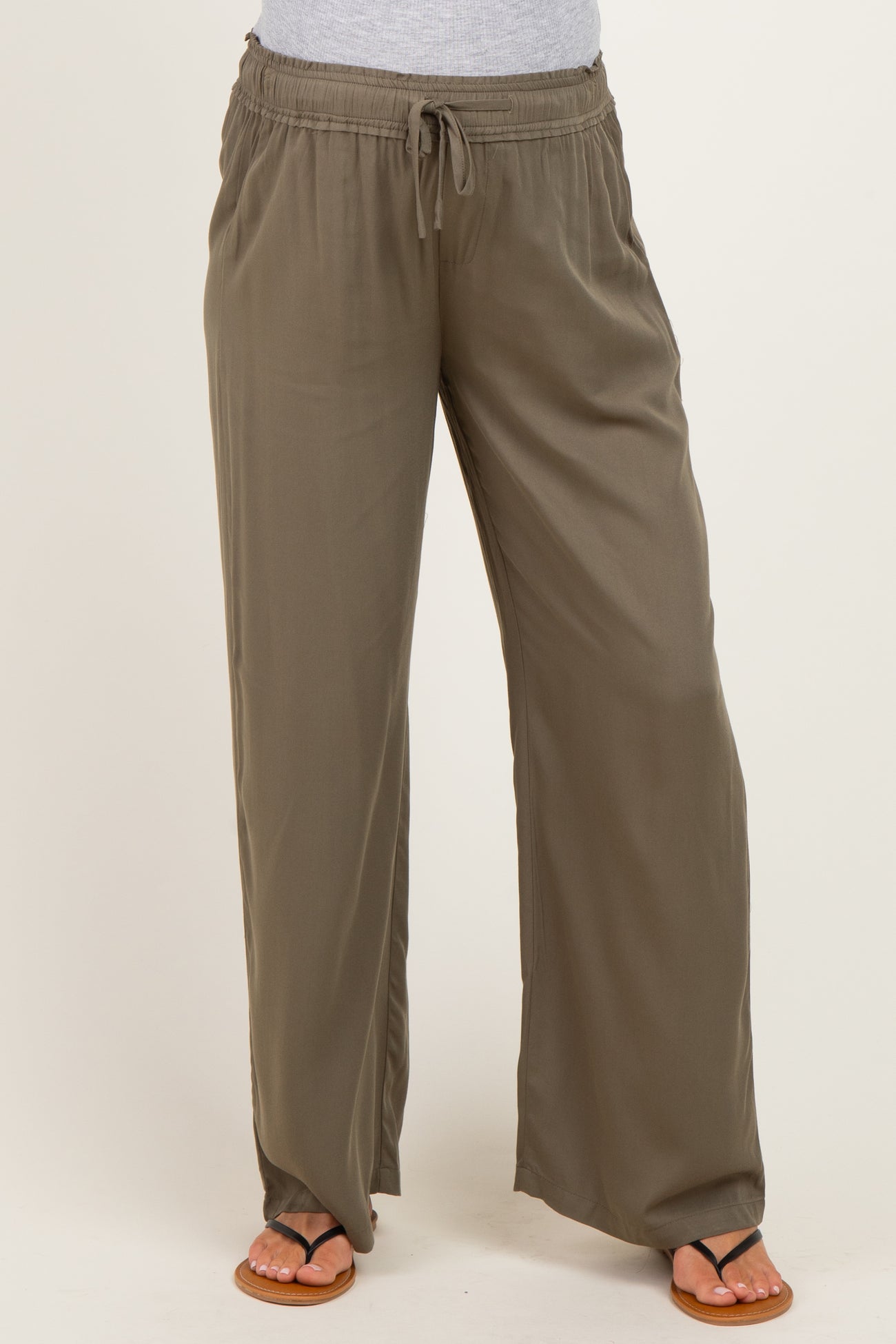 woman wearing olive green maternity wide-leg pants with an elastic waistband and drawstring detail