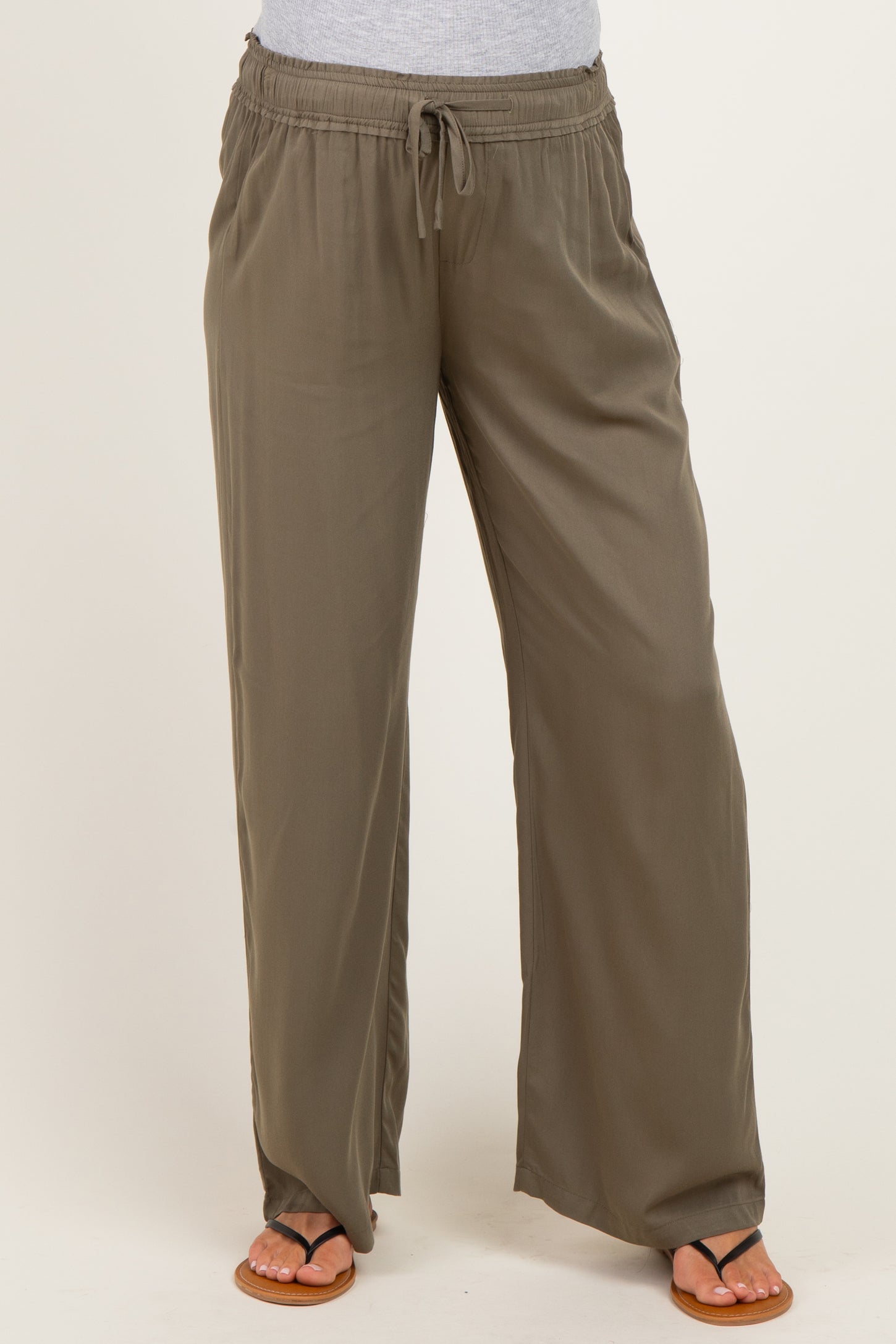 woman wearing olive green maternity wide-leg pants with an elastic waistband and drawstring detail