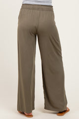 woman wearing olive green maternity wide-leg pants, view from the back