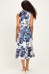 woman wearing a sleeveless blue and white floral midi dress with a ruffled hem, viewed from the back