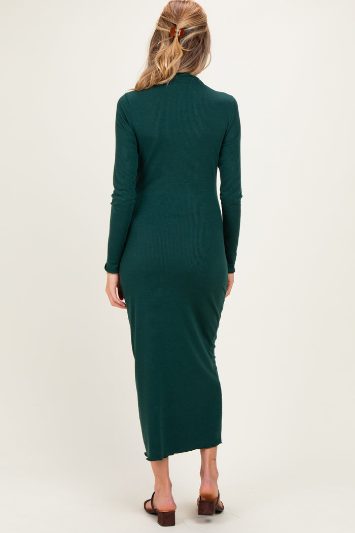 woman wearing a dark green long sleeve maternity dress with a form-fitting silhouette