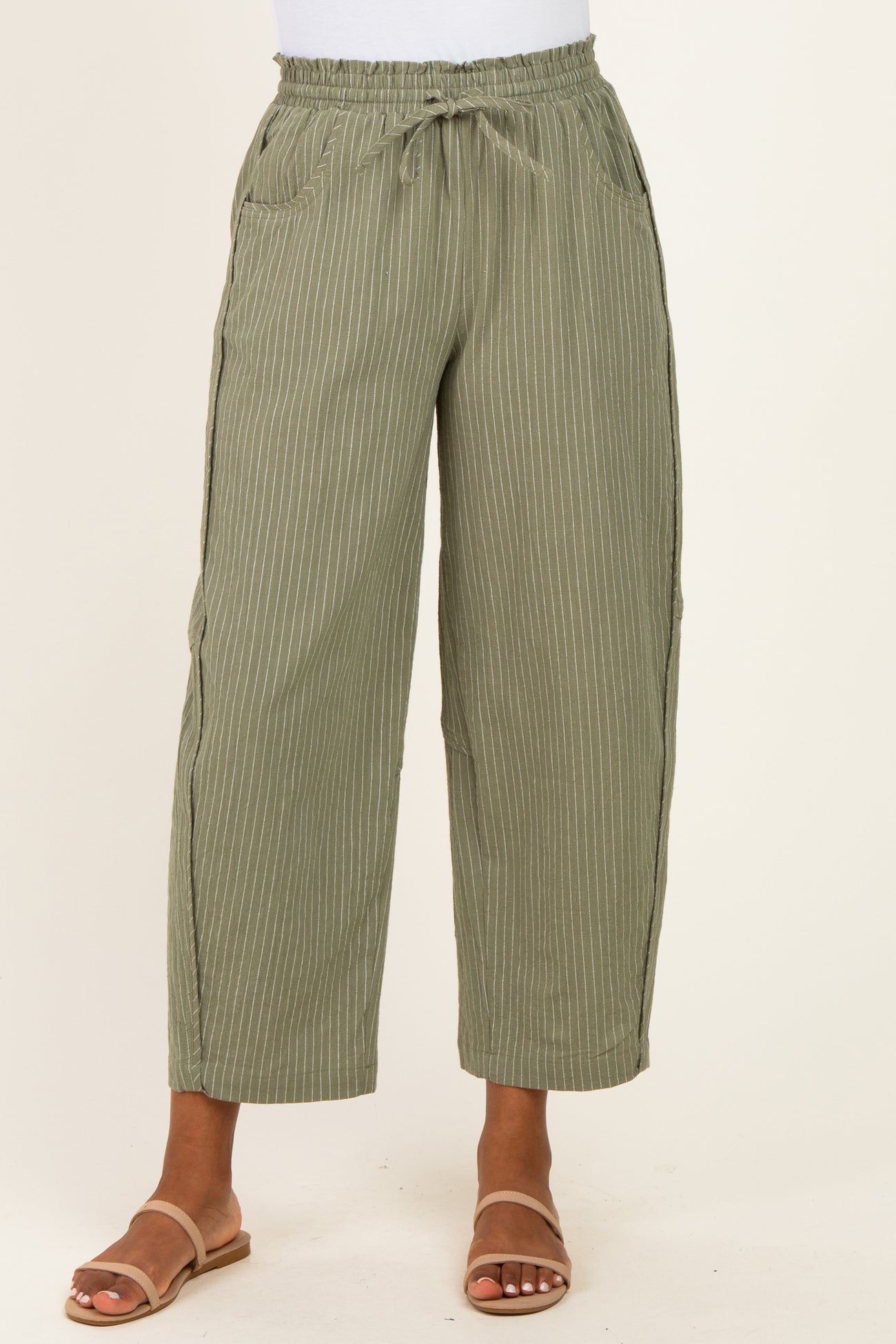 women wearing olive green striped wide-leg pants with an elastic waistband and pockets