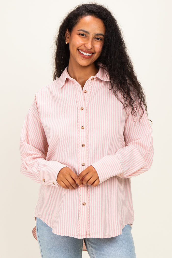 woman wearing a pink and white striped maternity button-up shirt with long sleeves and a relaxed fit