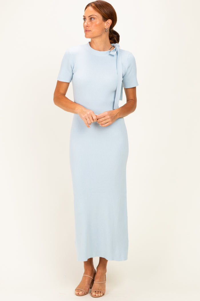woman wearing a light blue ribbed maxi dress with short sleeves and a tie detail at the shoulder
