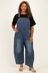 woman wearing a black oversized t-shirt and blue denim plus size overalls with wide legs