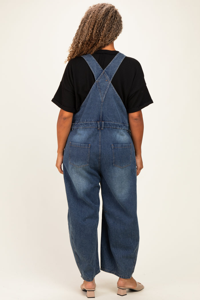 woman wearing a black oversized t-shirt and blue denim overalls, viewed from the back