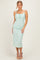 woman wearing a mint green lace midi dress with adjustable straps and a fitted silhouette