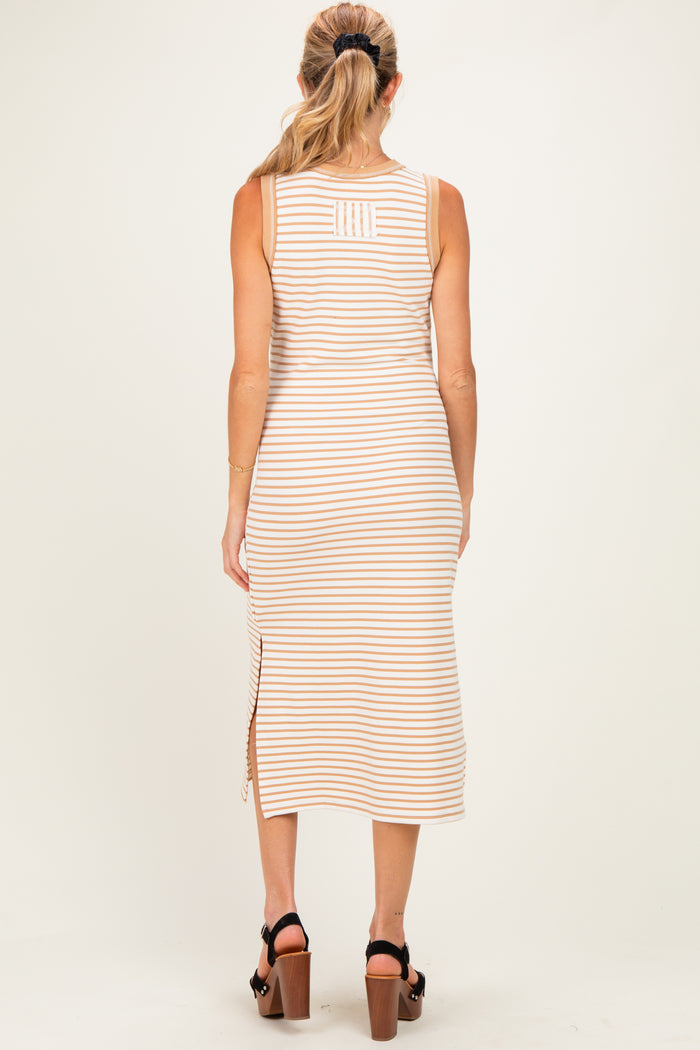 woman wearing a striped beige maternity dress with side slit and a fitted silhouette, shown from the back