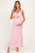 woman wearing a pink floral maternity maxi dress and holding her baby bump