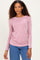 woman wearing a light pink ribbed long sleeve top with a boat neckline and stylish layered necklace paired with blue jeans