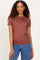 woman wearing a rust brown short sleeve top paired with blue jeans and layered necklaces