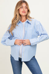 woman wearing a light blue striped maternity button-up shirt and showing her baby bump