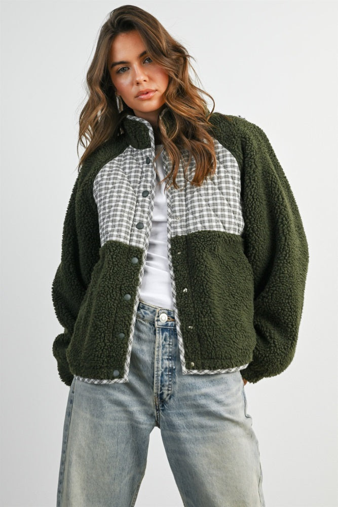 woman wearing an olive green and plaid check oversized button-up fleece jacket with dropped shoulders and a relaxed fit
