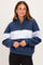 woman wearing a navy and grey color block quarter-zip sweatshirt with a relaxed fit and long sleeves