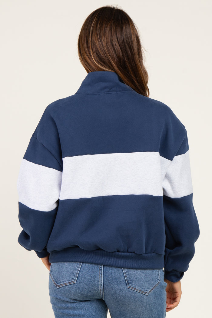 woman wearing a navy and gray striped maternity sweatshirt, showing a relaxed fit from the back
