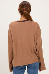 woman wearing a brown striped long sleeve oversized top with dropped shoulders and back view displayed