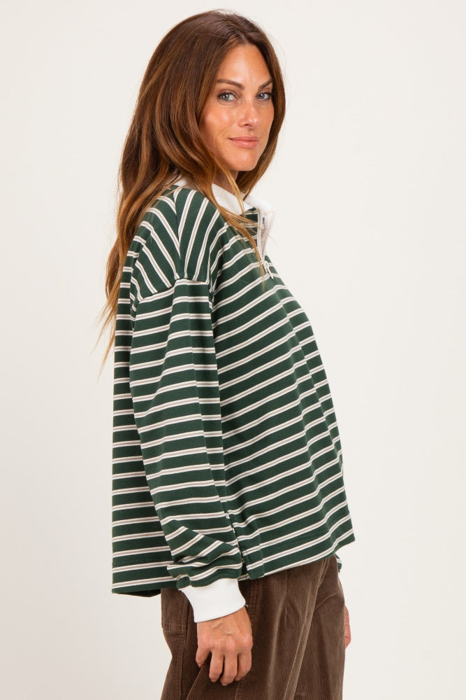 woman wearing a green and white striped long sleeve pullover with a collar and oversized fit