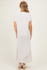 woman wearing a striped maxi dress with short sleeves and a side slit, viewed from the back