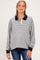 woman wearing a striped maternity pullover with a navy collar and a visible baby bump