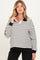 woman wearing a black and white striped maternity polo shirt with a collar and long sleeves