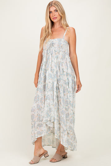 woman wearing a flowy white floral maxi dress with tie front detail and spaghetti straps