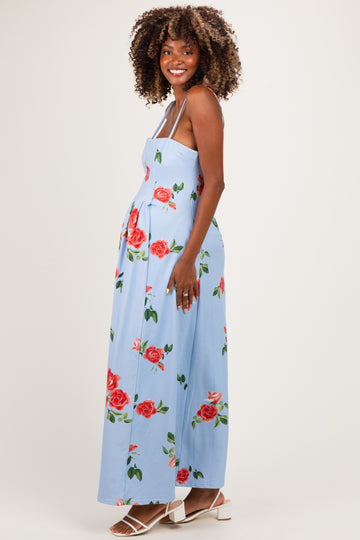 woman wearing a light blue floral maternity maxi dress, showcasing her baby bump