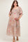 woman wearing a floral maternity plus dress with smocked bodice and tiered skirt, holding her baby bump