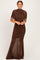 woman wearing a brown ruched maxi dress with short sleeves and a flattering silhouette